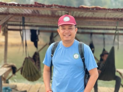 Mr. Sytha Nan, founder of REEC, on a visit to a rural community